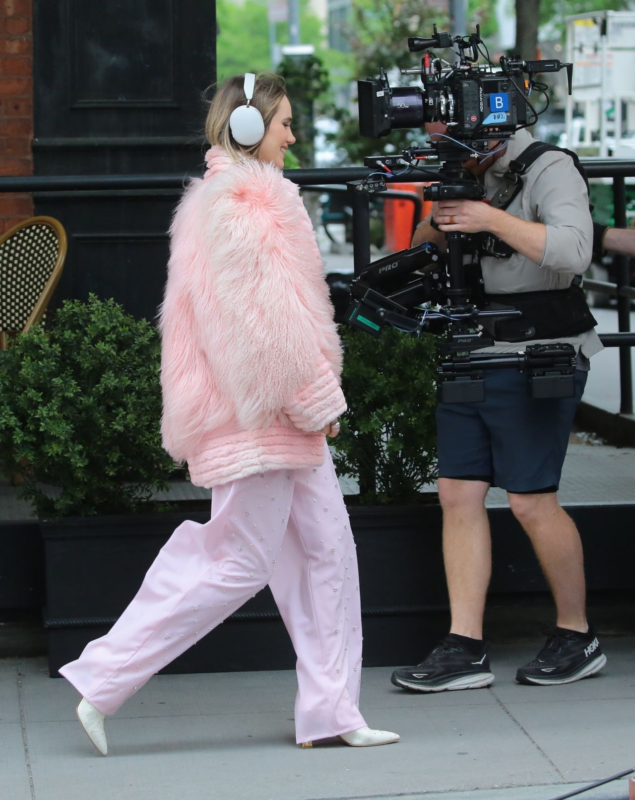 Suki Waterhouse Rocks Sonos Headphones and Pretty in Pink Attire on a Film Set05